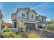 Two-story home with a charming front yard, a two car garage and a beautifully landscaped driveway at 688 Monroe Hill Pl, Henderson, NV 89011