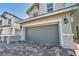 Two-story home features a two car garage with a charming brick driveway and mature landscaping in the front yard at 688 Monroe Hill Pl, Henderson, NV 89011