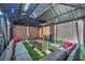 Backyard gazebo featuring sectional sofa, throw pillows, end tables, and string lights at 688 Monroe Hill Pl, Henderson, NV 89011