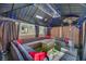 Cozy outdoor gazebo with string lights, sectional seating, throw pillows, and a coffee table at 688 Monroe Hill Pl, Henderson, NV 89011