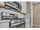 Gourmet kitchen featuring stainless steel range and microwave over white subway tile at 688 Monroe Hill Pl, Henderson, NV 89011