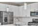 Contemporary kitchen with stainless steel appliances and modern pendant lighting at 688 Monroe Hill Pl, Henderson, NV 89011