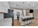 Stylish kitchen with stainless steel appliances, white cabinets, quartz countertops, and barstool seating at 688 Monroe Hill Pl, Henderson, NV 89011