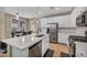 Bright kitchen features an island, stainless steel appliances, and convenient access to the dining area at 688 Monroe Hill Pl, Henderson, NV 89011