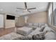 Spacious living room features plush rug, modern ceiling fan, and a large comfortable sectional at 688 Monroe Hill Pl, Henderson, NV 89011
