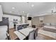 Open-concept living space connects kitchen, dining, and living areas, featuring modern finishes at 688 Monroe Hill Pl, Henderson, NV 89011