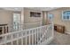 Open loft area with a white railing, natural light and wood-style console at 688 Monroe Hill Pl, Henderson, NV 89011