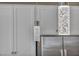 Modern pendant lighting detail over white kitchen cabinets and backsplash at 688 Monroe Hill Pl, Henderson, NV 89011
