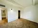 Bright bedroom with carpet, closet, white walls and access to the bathroom at 700 N Minnesota St, Las Vegas, NV 89107