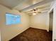 Bedroom with a ceiling fan, carpet, white walls, and an open closet at 700 N Minnesota St, Las Vegas, NV 89107