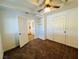 Cozy bedroom features neutral carpet, ceiling fan and a built-in storage area, offering comfort and functionality at 700 N Minnesota St, Las Vegas, NV 89107