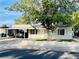 Street view of the home featuring a covered carport and mature landscaping at 700 N Minnesota St, Las Vegas, NV 89107