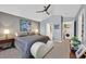 Bright bedroom featuring hardwood floors, ceiling fan, and laundry room access at 701 Wheat Ridge Ln # 203, Las Vegas, NV 89145