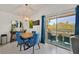 Dining area features a modern light fixture, balcony access, and seating for four at 701 Wheat Ridge Ln # 203, Las Vegas, NV 89145