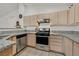 Bright kitchen with stainless steel appliances, granite countertops, and wood cabinets at 701 Wheat Ridge Ln # 203, Las Vegas, NV 89145