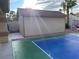 Tan backyard shed with view of pickleball court and landscaping under a sunny sky at 7020 King Solomons Ct, Las Vegas, NV 89117