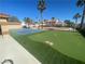 Backyard featuring a putting green and pickleball court with palm trees in the background at 7020 King Solomons Ct, Las Vegas, NV 89117