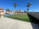 Backyard featuring a putting green and pickleball court with palm trees surrounding at 7020 King Solomons Ct, Las Vegas, NV 89117