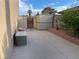 View of the backyard with a block wall, storage, and trees against a sunny blue sky at 7020 King Solomons Ct, Las Vegas, NV 89117