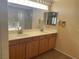 Bathroom with dual sinks, tile floor, and a shower with glass door at 7020 King Solomons Ct, Las Vegas, NV 89117