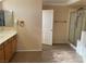 Bathroom with dual sinks, tile floor, and a shower with glass door at 7020 King Solomons Ct, Las Vegas, NV 89117