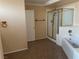 Well-lit bathroom with shower, bathtub, and tiled floors at 7020 King Solomons Ct, Las Vegas, NV 89117