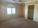 Comfortable bedroom featuring a ceiling fan, a window with shutters, and a convenient closet at 7020 King Solomons Ct, Las Vegas, NV 89117