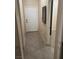 Hallway with tile flooring, a white entry door, and views into adjacent rooms at 7020 King Solomons Ct, Las Vegas, NV 89117