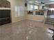 Inviting living room area showcasing tile flooring and a staircase with a modern design at 7020 King Solomons Ct, Las Vegas, NV 89117