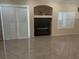 Bright living room featuring tile floors, plantation shutters, and a built-in media center at 7020 King Solomons Ct, Las Vegas, NV 89117