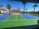 Outdoor pickleball court with green and blue surface, surrounded by palm trees at 7020 King Solomons Ct, Las Vegas, NV 89117