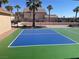 View of the outdoor pickleball court with palm trees and residential buildings in the background at 7020 King Solomons Ct, Las Vegas, NV 89117