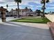 Manicured putting green and view of the pickleball court in a landscaped backyard at 7020 King Solomons Ct, Las Vegas, NV 89117