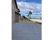 Side yard with lush green grass and view of palm trees and beautiful blue sky at 7020 King Solomons Ct, Las Vegas, NV 89117