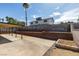 Backyard featuring a large patio with a covered area and brick walls around the perimeter at 706 Greenway Rd, Henderson, NV 89002