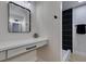 Modern bathroom featuring vanity, black hardware, and a black tiled shower at 706 Greenway Rd, Henderson, NV 89002