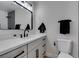 Bathroom vanity with black fixtures and a modern mirror with a white countertop at 706 Greenway Rd, Henderson, NV 89002
