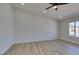Bright and spacious bedroom featuring hardwood floors, a ceiling fan, and large windows at 706 Greenway Rd, Henderson, NV 89002