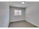 A bedroom featuring neutral-colored walls and carpet and a bright window at 706 Greenway Rd, Henderson, NV 89002