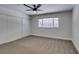 Carpeted bedroom with large window and closet with sliding doors at 706 Greenway Rd, Henderson, NV 89002