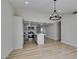 Open-concept area with wood-look floors flowing into a bright kitchen with a center island at 706 Greenway Rd, Henderson, NV 89002