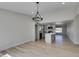 Dining area featuring wood-look floors, modern light fixture, seamlessly connected to the kitchen area at 706 Greenway Rd, Henderson, NV 89002