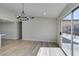 Open dining space with wood-look floors, modern light fixture, and sliding doors to backyard at 706 Greenway Rd, Henderson, NV 89002