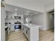 Kitchen with island, white cabinets and countertops, and stainless steel appliances at 706 Greenway Rd, Henderson, NV 89002