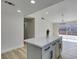 Kitchen island featuring a quartz countertop and views to backyard at 706 Greenway Rd, Henderson, NV 89002