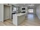 Kitchen with island, white cabinets and countertops, and stainless steel appliances, open floor plan at 706 Greenway Rd, Henderson, NV 89002