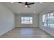 Bright living room with wood floors, ceiling fan, and large windows providing ample natural light at 706 Greenway Rd, Henderson, NV 89002