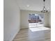 Living room with wood floors and sliding glass door leading to a patio at 706 Greenway Rd, Henderson, NV 89002