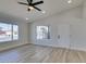 Bright living room featuring wood floors, vaulted ceilings, a ceiling fan, and a front door at 706 Greenway Rd, Henderson, NV 89002