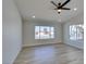 Bright living room featuring wood floors, a ceiling fan, and lots of natural light from large windows at 706 Greenway Rd, Henderson, NV 89002